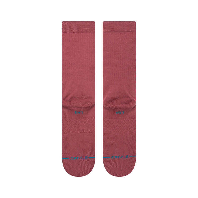 Lifestyle shot of a person wearing Stance mens Icon Solid Color Cotton Crew Socks, highlighting their stylish look and medium cushioning support.