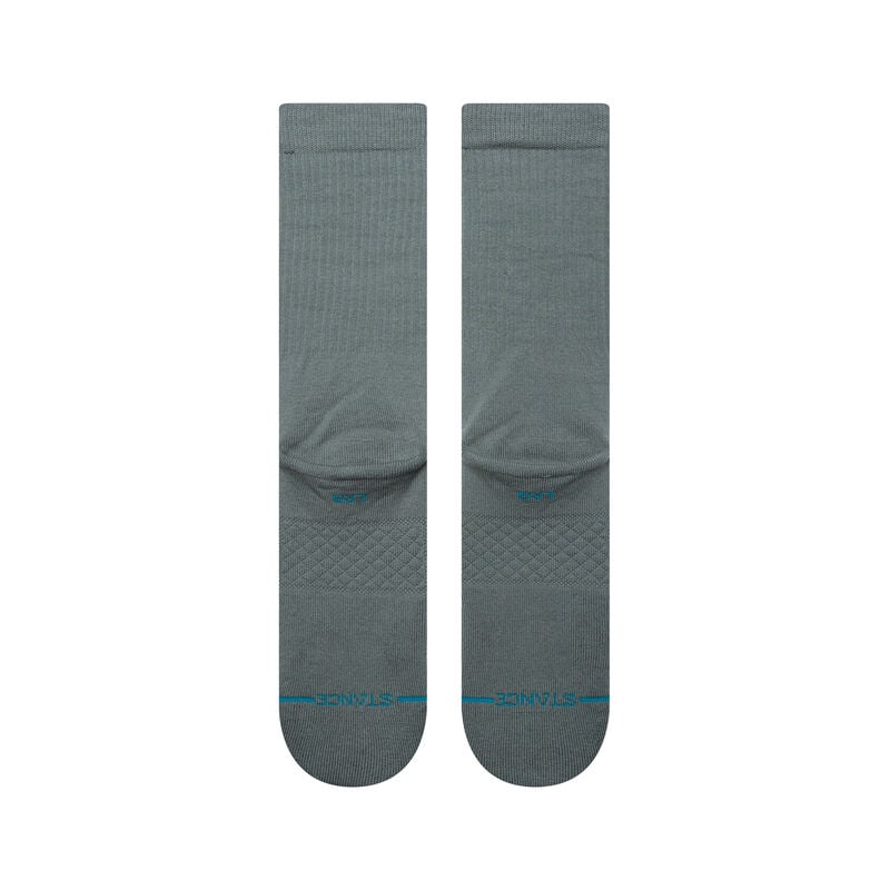 Lifestyle shot of a person wearing Stance mens Icon Solid Color Cotton Crew Socks, illustrating comfort and support in daily activities.