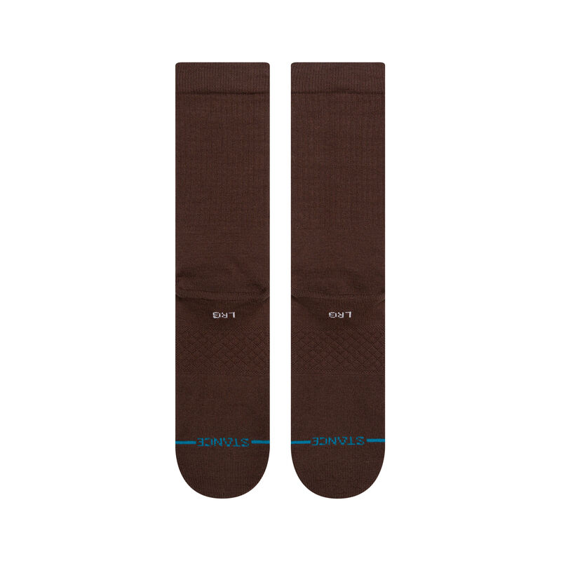 Stance mens Icon Solid Color Cotton Crew Socks in brown worn with casual footwear, emphasizing their stylish look and versatility.