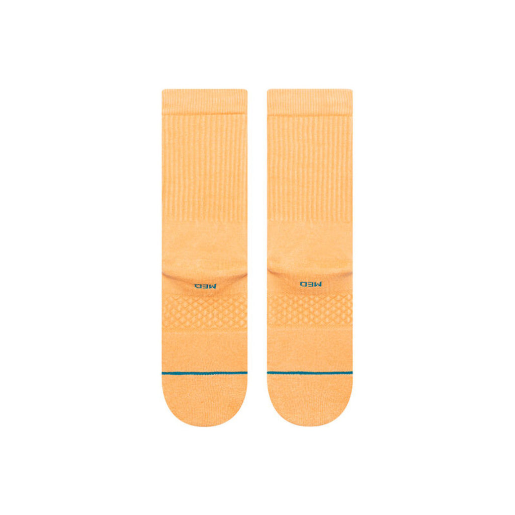 Lifestyle image of Stance mens Icon Crew socks in Washed Peach, perfect for casual wear and pairing with sneakers.