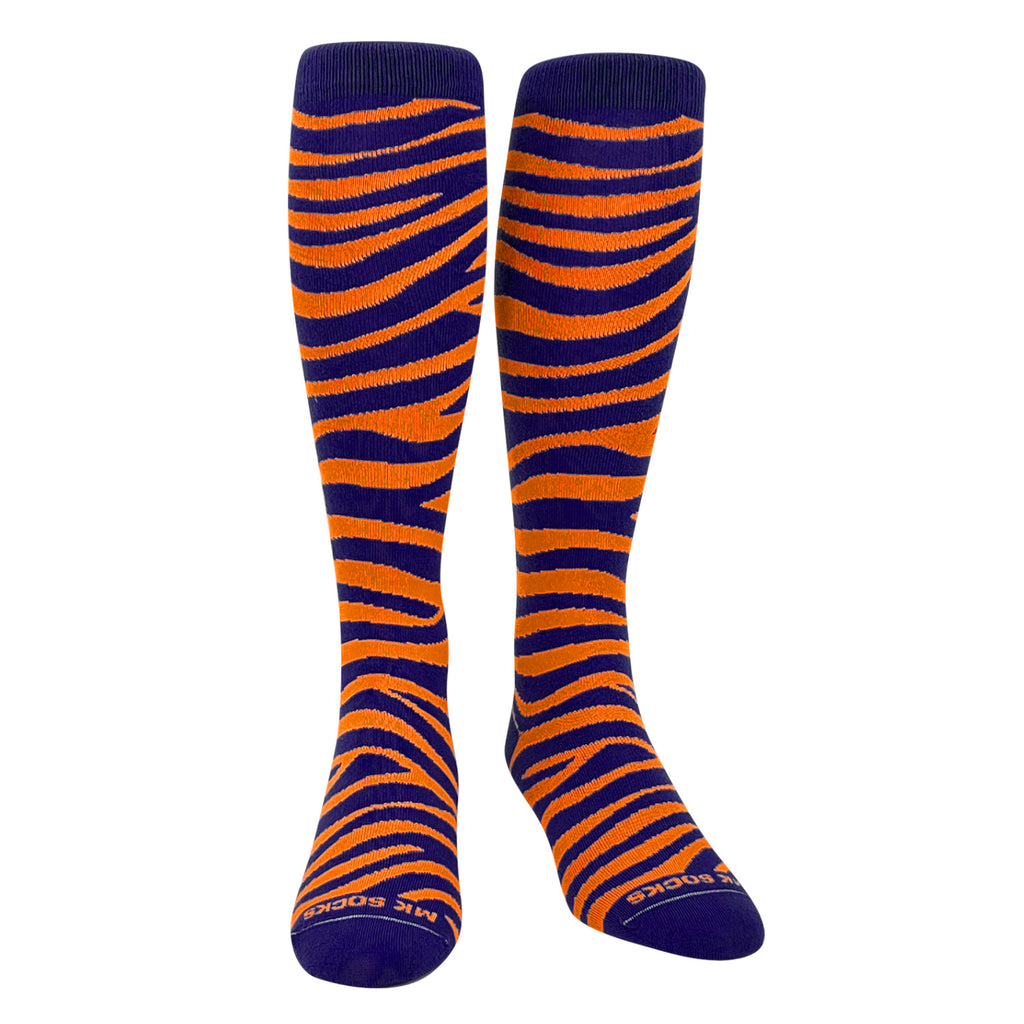 A pair of navy and orange tiger striped knee-high socks designed for sports.