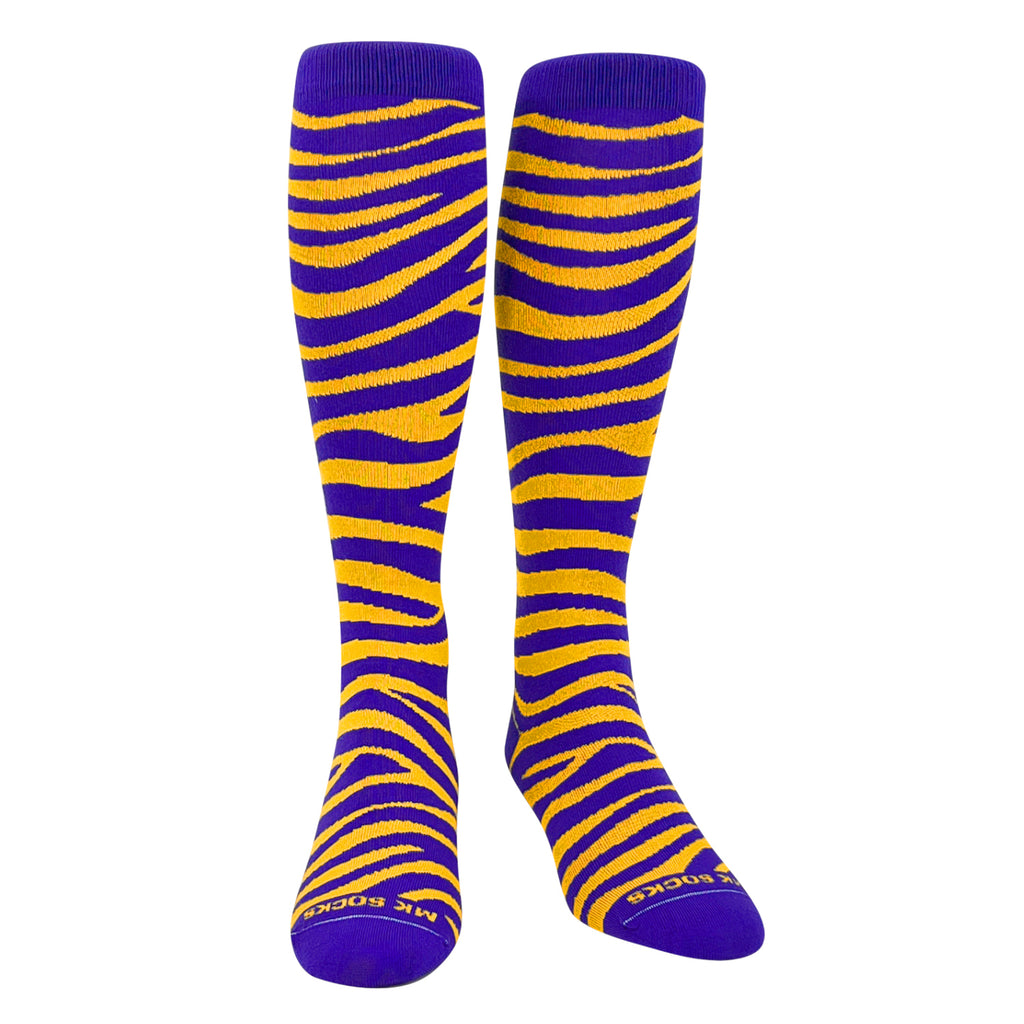 A pair of purple and gold striped socks designed for sports, reaching up to the knee.