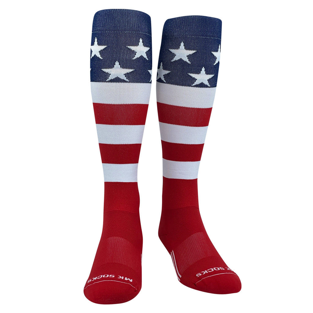 A pair of knee-high sports socks featuring the USA flag design with red, white, and blue colors and stars and stripes pattern.