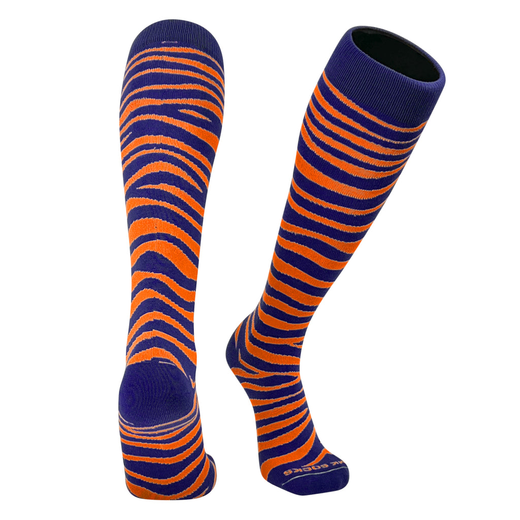 A pair of navy and orange tiger striped knee-high socks designed for sports.