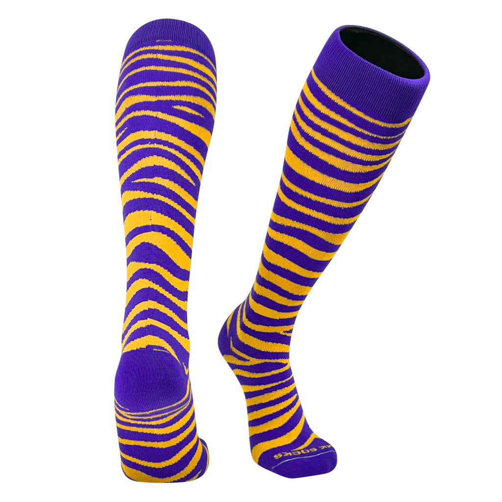 A pair of purple and gold striped socks designed for sports, reaching up to the knee.